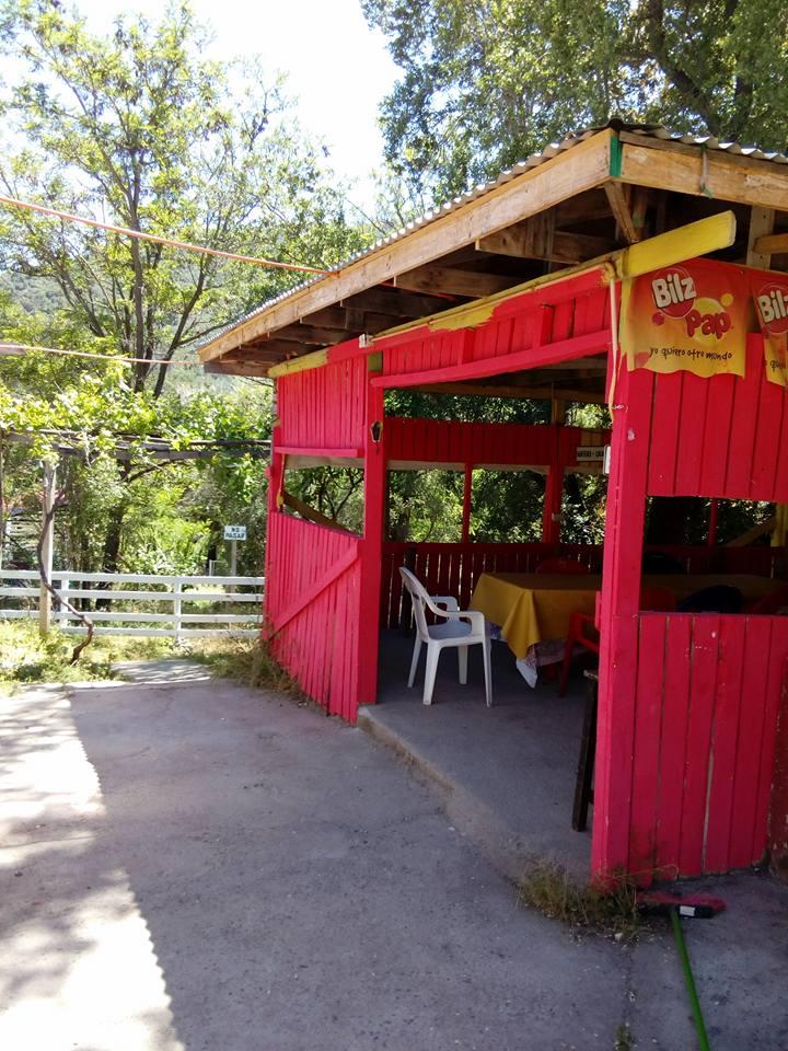Terraza cubierta de madera con mesa y sillas